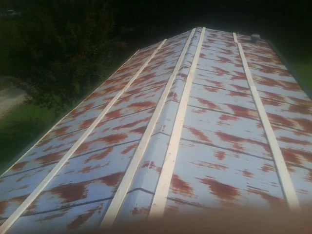 Rusted metal roof panels with new wood purlins before replacement — Storm Damage Roof Repair in Lynn by Roofing Brothers